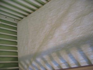 ...then another waterproof pad (this is a nice one that goes all the way around the mattress, but any old crib-sized pad will do)...