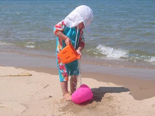 one-piece surfer style swim suit and flap hat