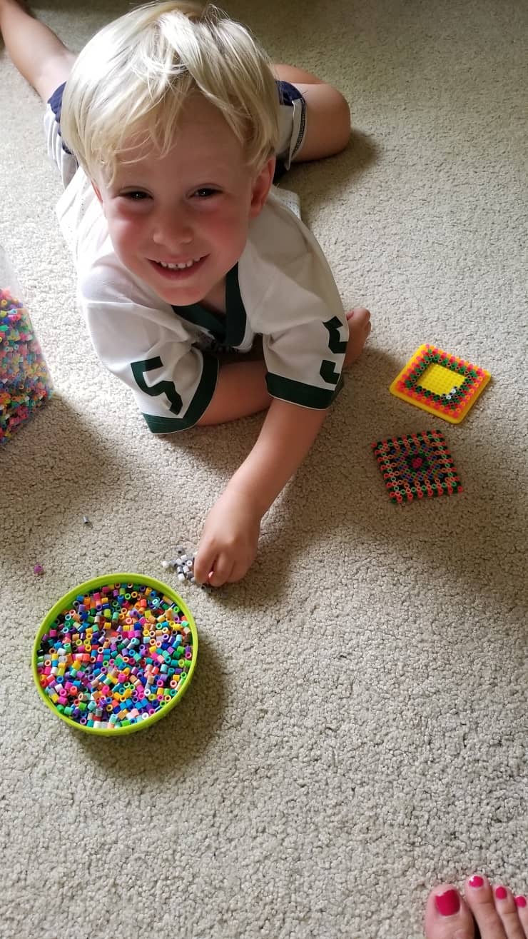 Heal your brain after a concussion so you're more resilient against further bumps. boy playing with beads