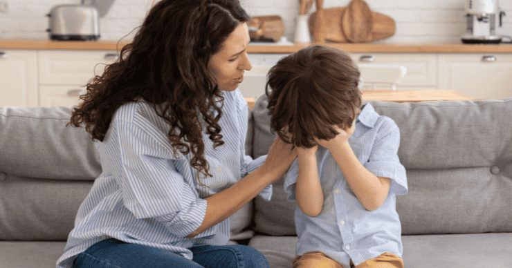 We’ve avoided a lot of the chore wars because our kids know the expectations. Because our kids know the routines, we have less stress and less temper tantrums. mother comforting son