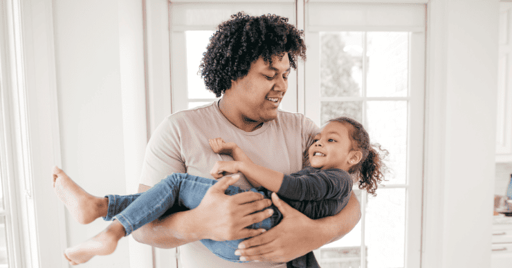 The key though, is motivating them with something that they want. It’s really taken away the opportunity for nagging. There’s no motivating them with guilt or shame. dad holding daughter